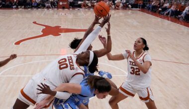 Texas center Kyla Oldacre (00) battles North Carolina guard Indya Nivar, rear, and forward Ciera Toomey, center, for a rebound during the second half of an NCAA college basketball game in Austin, Texas, Thursday, Dec. 4, 2025. (AP Photo/Eric Gay)