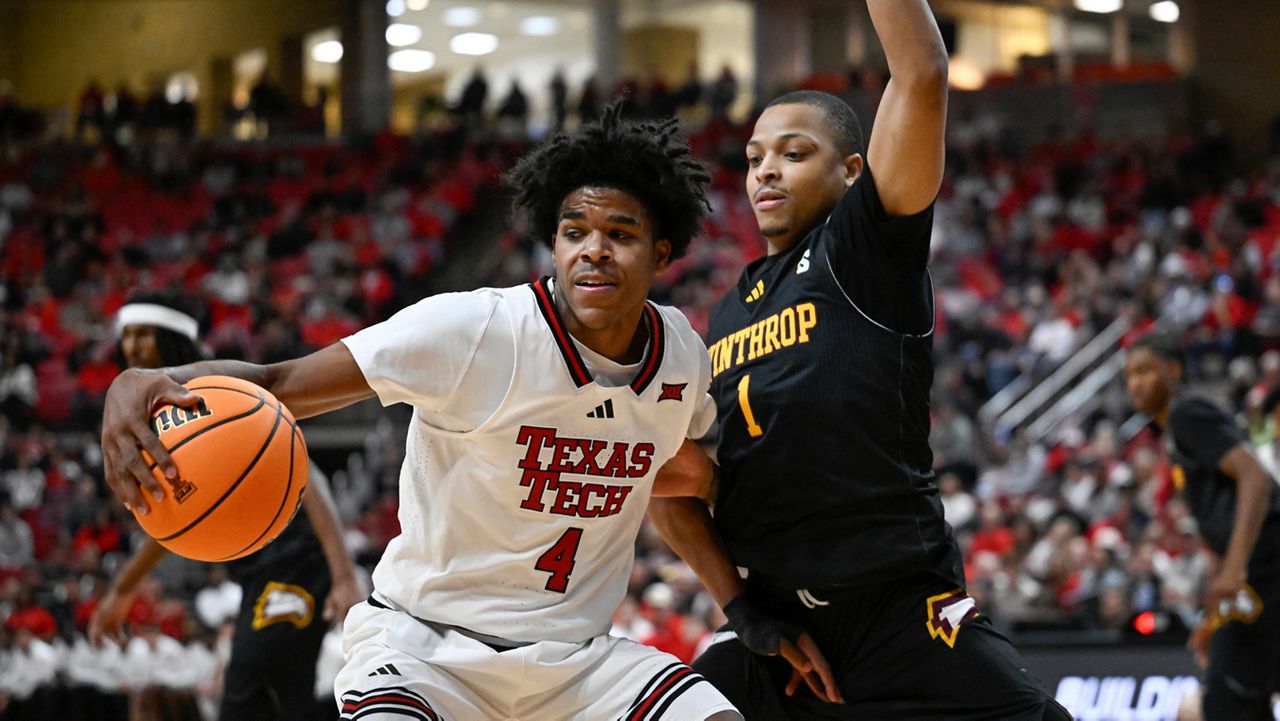 Texas Tech guard Christian Anderson (4) drives to the basket against Winthrop guard Isaiah Wilson (1) during the first half of an NCAA college basketball game Sunday, Dec. 28, 2025, in Lubbock, Texas. (AP Photo/Justin Rex)