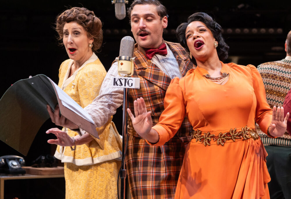 Actors in colorful vintage clothes sing on stage