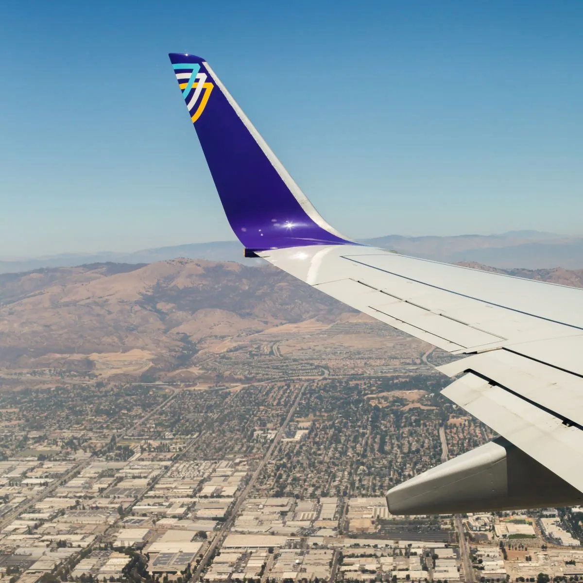 The wing of an Avelo airplane