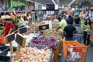 Shoppers browse the produce section at India Bazaar in Plano in August.