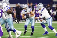 Dallas Cowboys running back Malik Davis (43 ) takes the hand off from quarterback Dak...