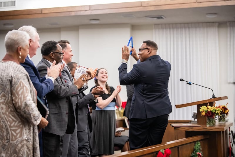 Sacher Dawson, Hope Farm Executive Director, accepts his service award for the work Hope Farm does for fatherless boys and their single mothers in the community at the Saints in Unity devotional in Fort Worth, Texas, on Nov. 16, 2025.