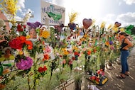 Red Cross volunteer Vanessa McElreath looks at “ Wall of Hope,” a memorial wall honoring the...