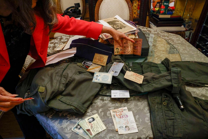 Jennifer Nguyen shows a collection of her and her husband’s ID cards from their time in...