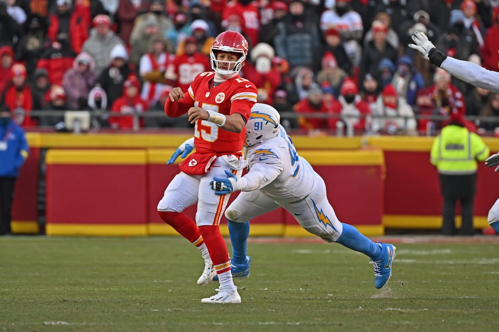 Kansas City Chiefs quarterback Patrick Mahomes (15) gets tackled from behind by Los Angeles...
