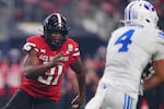 Texas Tech linebacker David Bailey (31) gives chase as BYU running back LJ Martin (4) runs the ball in the second half of a Big 12 Conference championship NCAA college football game Saturday, Dec. 6, 2025, in Arlington, Texas.