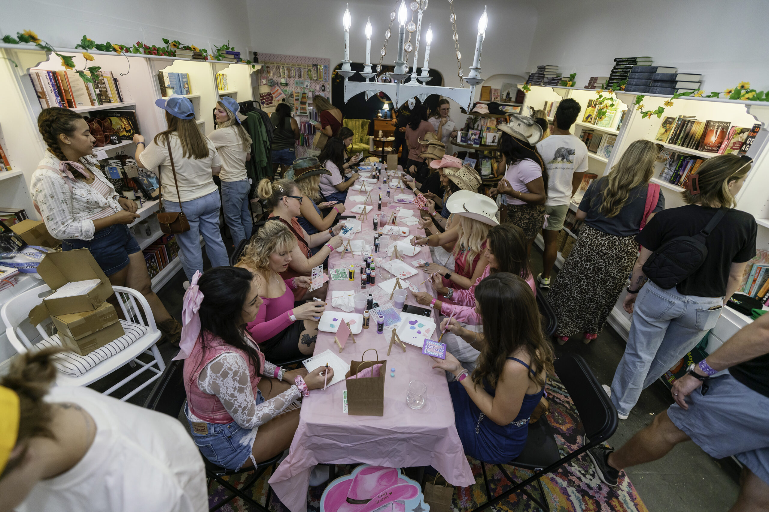 Sponsored: Ladies in pink crafting in a shop in Downtown Plano at the Wine Walk Barbie Rodeo. Photo by Ron Blea.