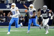 Chargers offensive tackle Bobby Hart (66) begins to celebrate as quarterback Justin Herbert...