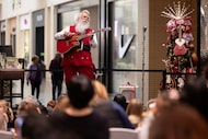 Joel Lagrone, an aerospace engineer and longtime singer, performs as Santa at the NorthPark...