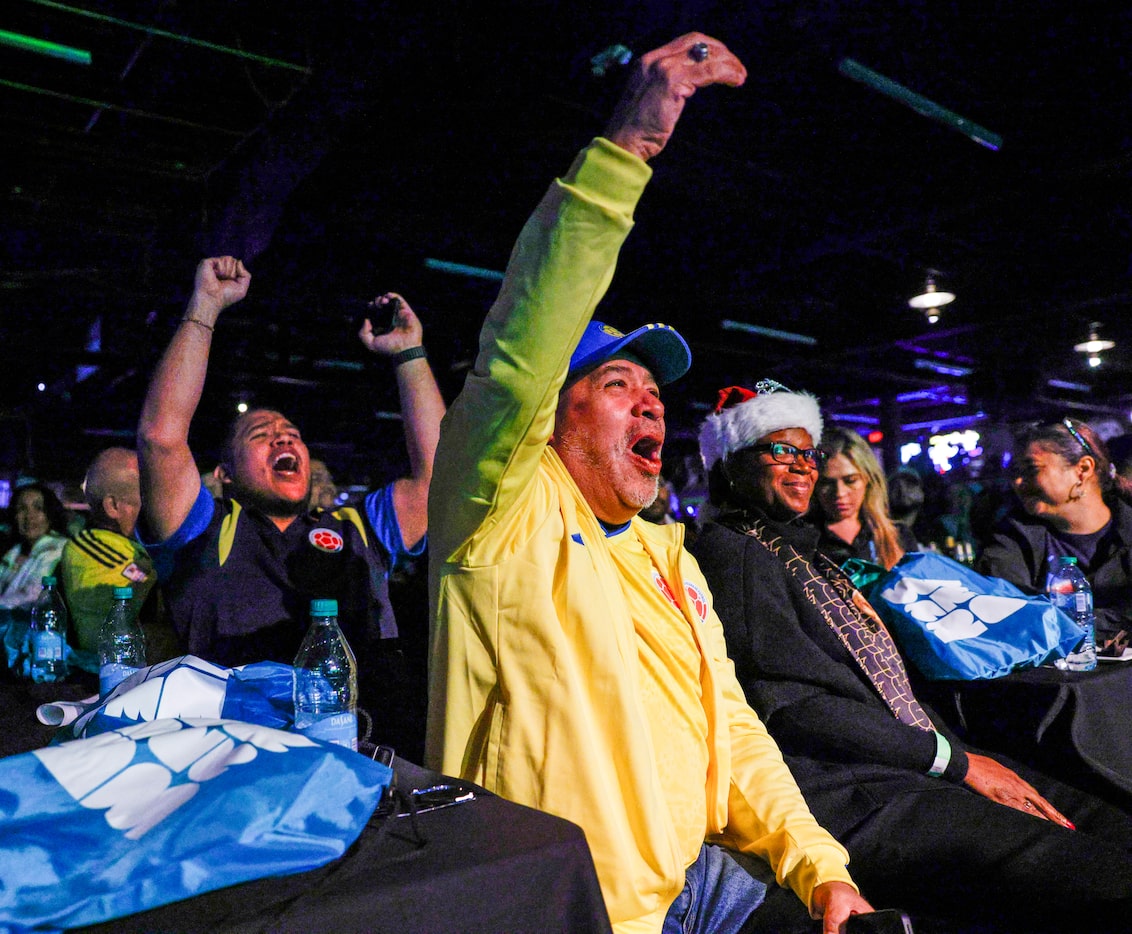 Grand Prairie resident Nick Morales, 34, (left) and Luis Morales, 63, cheer during the World...