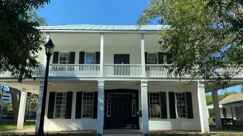The Kellum-Noble House exterior with trees shading its front