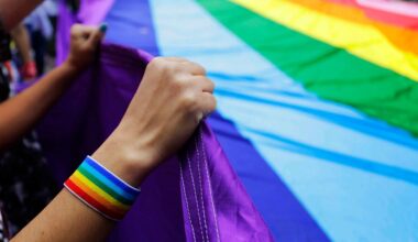 In this Sunday, June 3, 2018 file photo, revelers at the annual gay pride parade hold up a giant rainbow flag in Sao Paulo, Brazil. (AP Photo/Nelson Antoine, File)