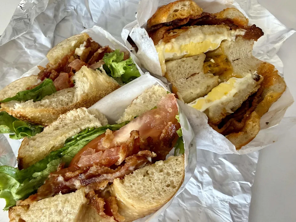 Dan’s Bagels has sandwiches on sourdough bagels, including a BLT, left, and a bacon-and-egg breakfast sandwich.