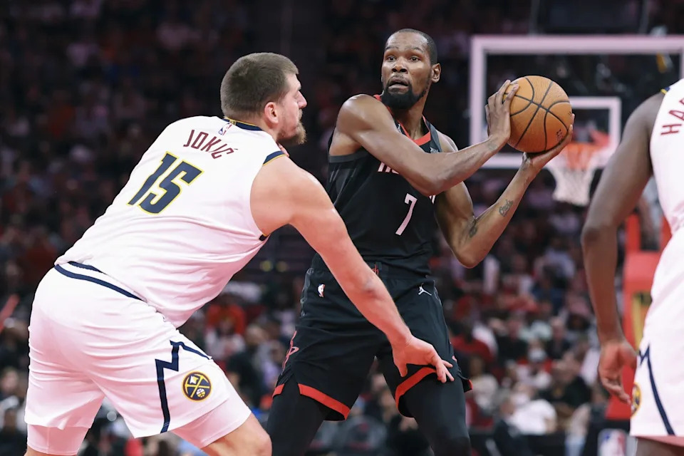 Nov 21, 2025; Houston, Texas, USA; Houston Rockets forward Kevin Durant (7) looks to pass the ball as Denver Nuggets center Nikola Jokic (15) defends during the second quarter at Toyota Center. Mandatory Credit: Troy Taormina-Imagn Images