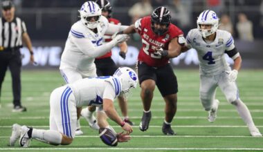 ARLINGTON, TEXAS - DECEMBER 06: Bear Bachmeier #47 of the BYU Cougars recovers a bad snap against t...