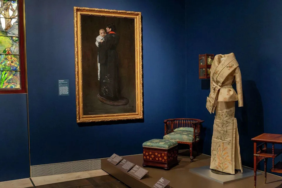 A jacket and skirt by John Galliano is seen near the painting, Mother and Child (The First Portait) c. 1888, in the Louvre Couture exhibition at the Museum of Fine Arts, Houston, Wednesday, Nov 19, 2025. (Kirk Sides/Houston Chronicle)
