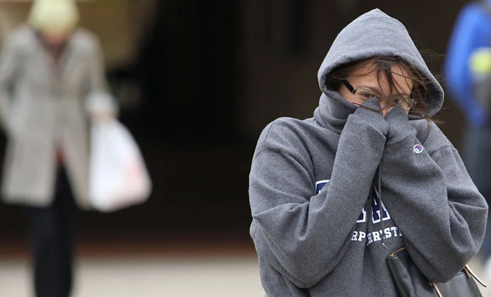 A Texas A&M University-Corpus Christi student shields her face from the cold in this archive photo.