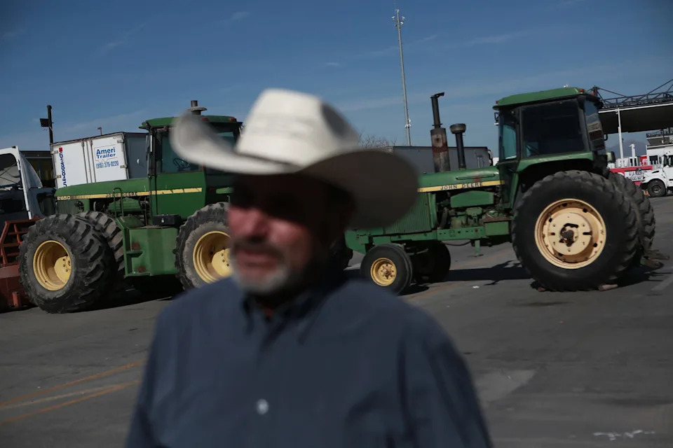 Mexican farmers block the Zaragoza-Ysleta International Bridge in Ciudad Juárez, Mexico, on Wednesday, Nov. 26, 2025. Agricultural machinery and tractors have been positioned at the crossing, halting commercial traffic for a third day. A line of tractor-trailers stretches for several kilometers as exports remain suspended. Only light vehicles are using alternate routes, facing significant delays. Protesters say the blockade will continue with no estimate for reopening.