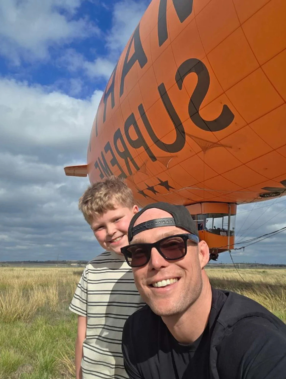 Seguin native Chris Larson and his son stand near a Marty Supreme blimp in New Braunfels, Texas, on December 26, 2025. (Courtesy of Blue Horizon Media)