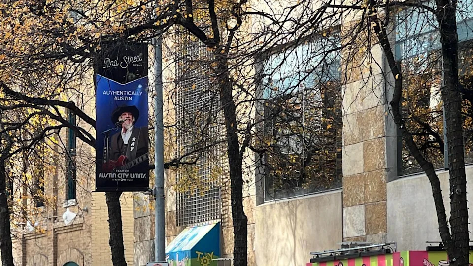 A banner of Ray Benson from Asleep At The Wheel was installed in downtown Austin’s 2nd Street District. Several banners in the area showcase iconic Austin and Texas performers who have performed on Austin PBS’s Austin City Limits. (KXAN Photo/Abigail Jones)