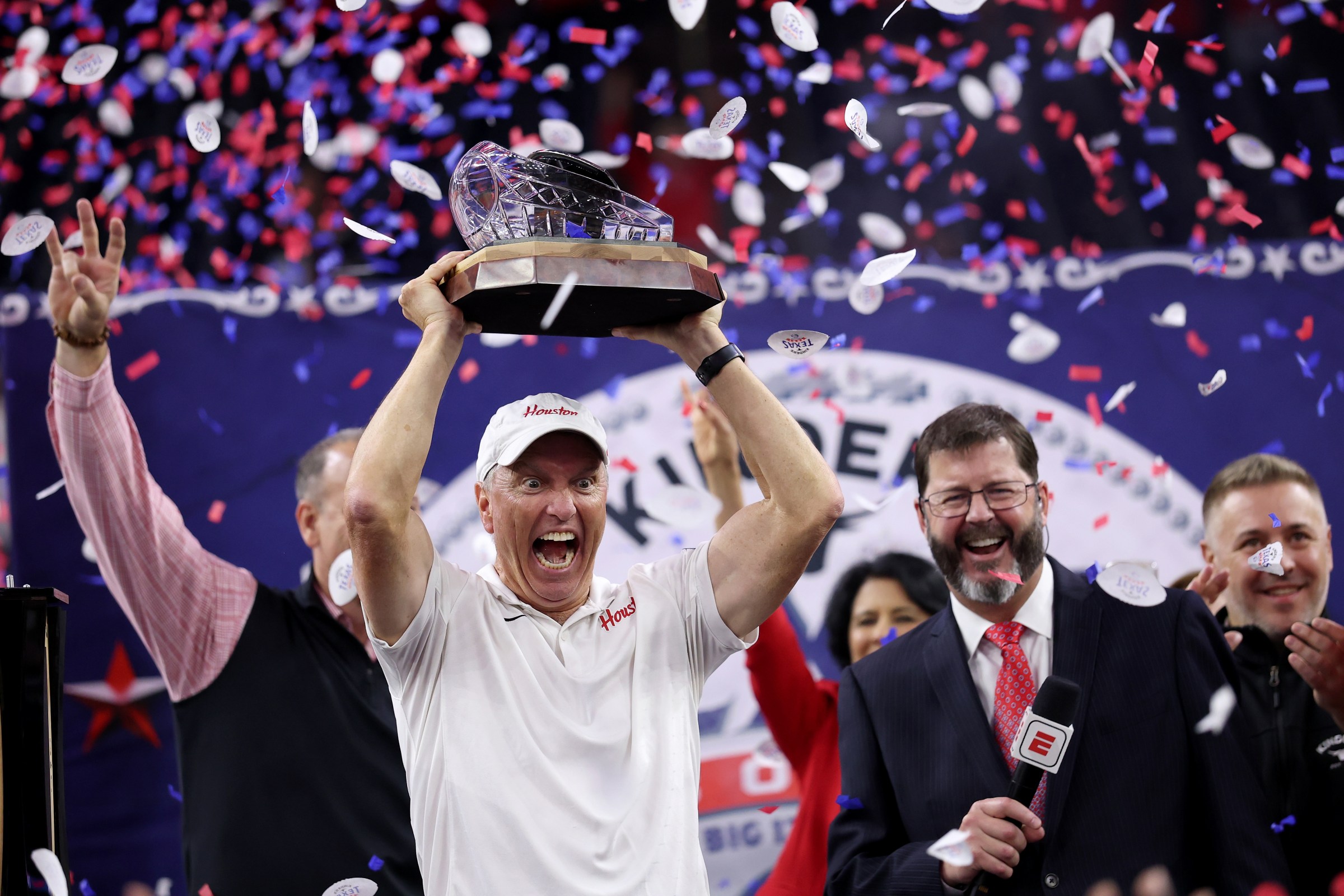 HOUSTON, TEXAS - DECEMBER 27: Head coach Willie Fritz of the Houston Cougars celebrates with the Texas Bowl Trophy after defeating the Louisiana State Tigers during the Kinder’s Texas Bowl at NRG Stadium on December 27, 2025 in Houston, Texas. (Photo by Tim Warner/Getty Images)