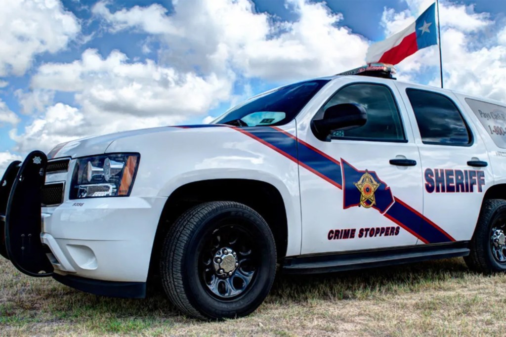Sheriff's vehicle with Texas flag on top.