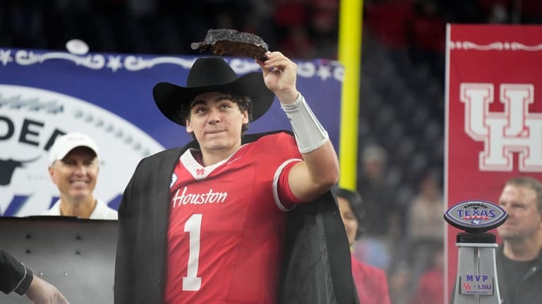 Houston quarterback Conner Weigman (1) wears a cowboy hat as...