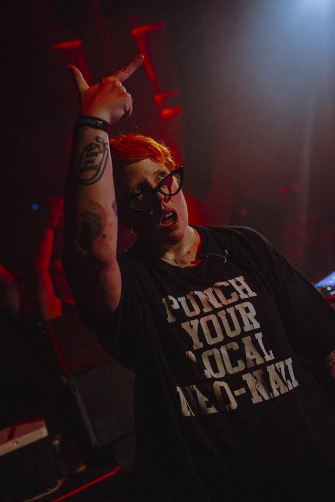 DJ The Blessed Madonna wearing a black t-shirt with white text on it.