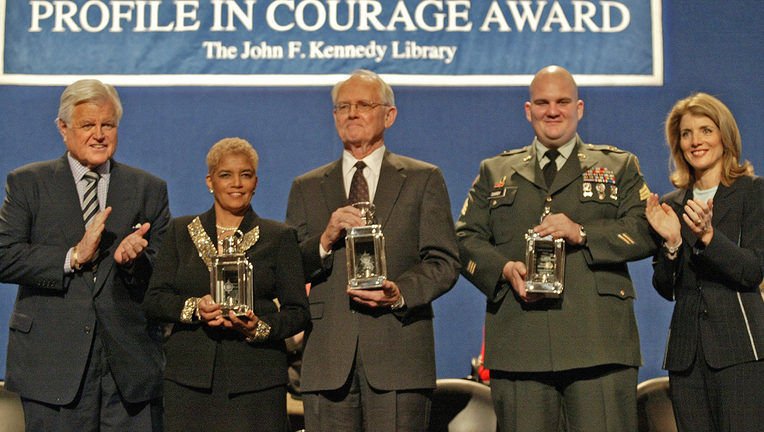 Former Texas Lt. Gov. Bill Ratliff stands in the center of a group of recipients of the John F. Kennedy Profile in Courage Award at the JFK library.