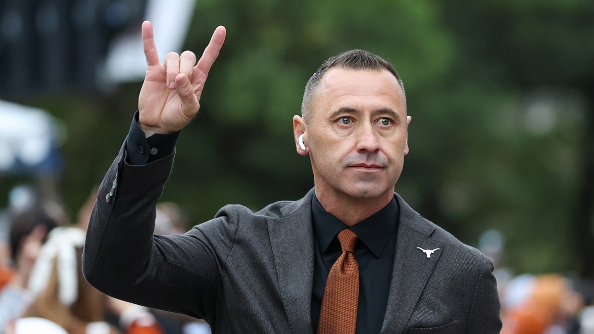 Steve Sarkisian with Texas salute
