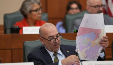 Texas state Rep. Carl H. Tepper looks through maps during a public hearing on congressional redistricting in Austin, Texas, Friday, Aug. 1, 2025. (AP Photo/Eric Gay)