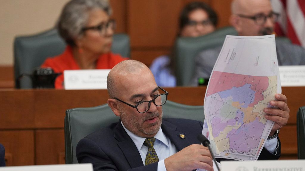 Texas state Rep. Carl H. Tepper looks through maps during a public hearing on congressional redistricting in Austin, Texas, Friday, Aug. 1, 2025. (AP Photo/Eric Gay)