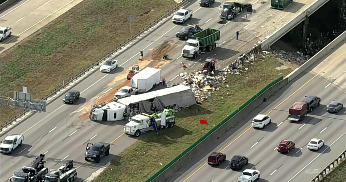 Semi hauling trash overturns on I-20 in Dallas, leading to miles of traffic backup