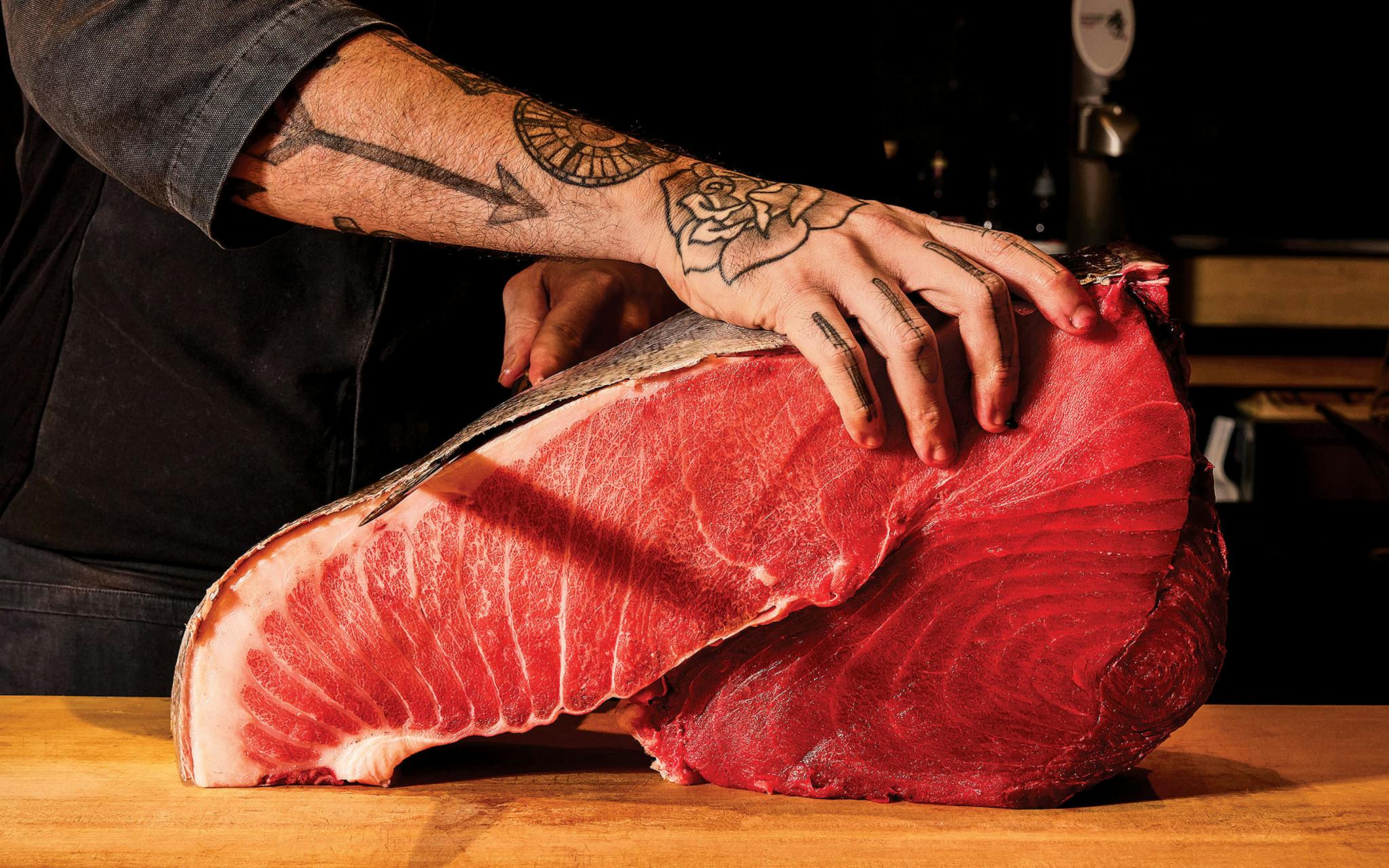 photo of chef slicing tuna
