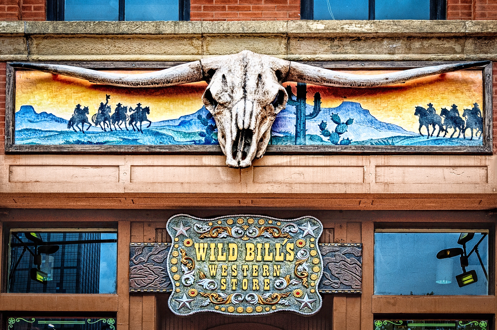 A longhorn skull decoration above the "Wild Bill's Western Store" sign in downtown Dallas.