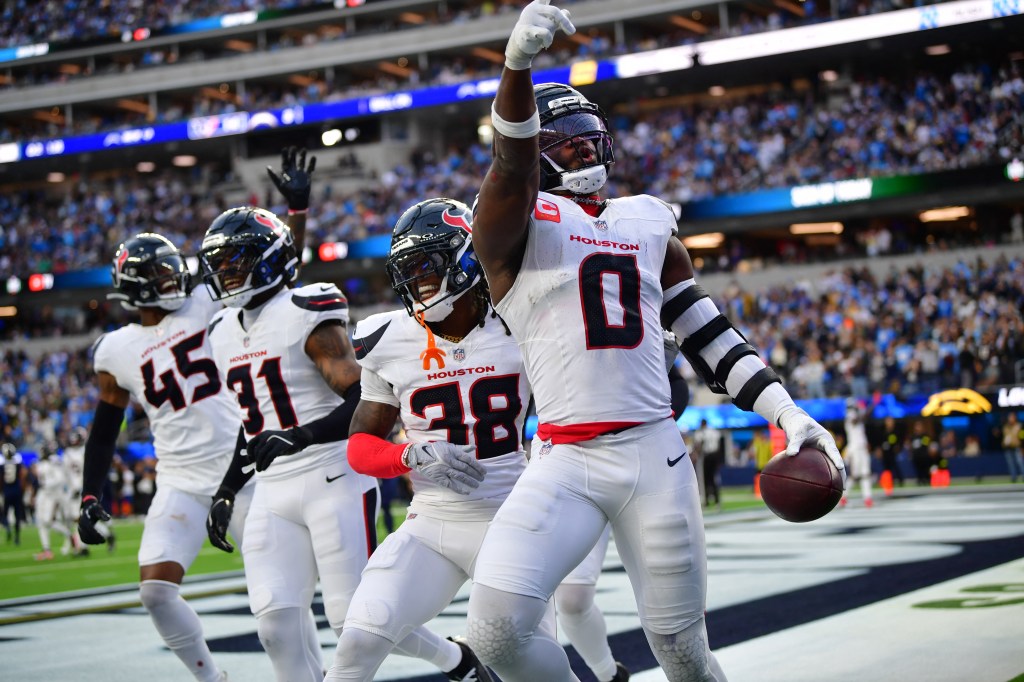 Houston Texans linebacker Azeez al-Shaair (0) celebrates with safety K'Von Wallace (38) after an interception.