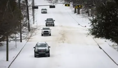 Cars navigate icy roads after Winter Storm Fern passes the area Sunday, Jan. 25, 2026, in Dallas.