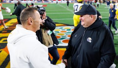Dec 31, 2025; Orlando, FL, USA; Texas Longhorns head coach Steve Sarkisian and Michigan Wolverines interim head coach Biff Poggi shake hands after a game at Camping World Stadium. Mandatory Credit: Matt Pendleton-Imagn Images