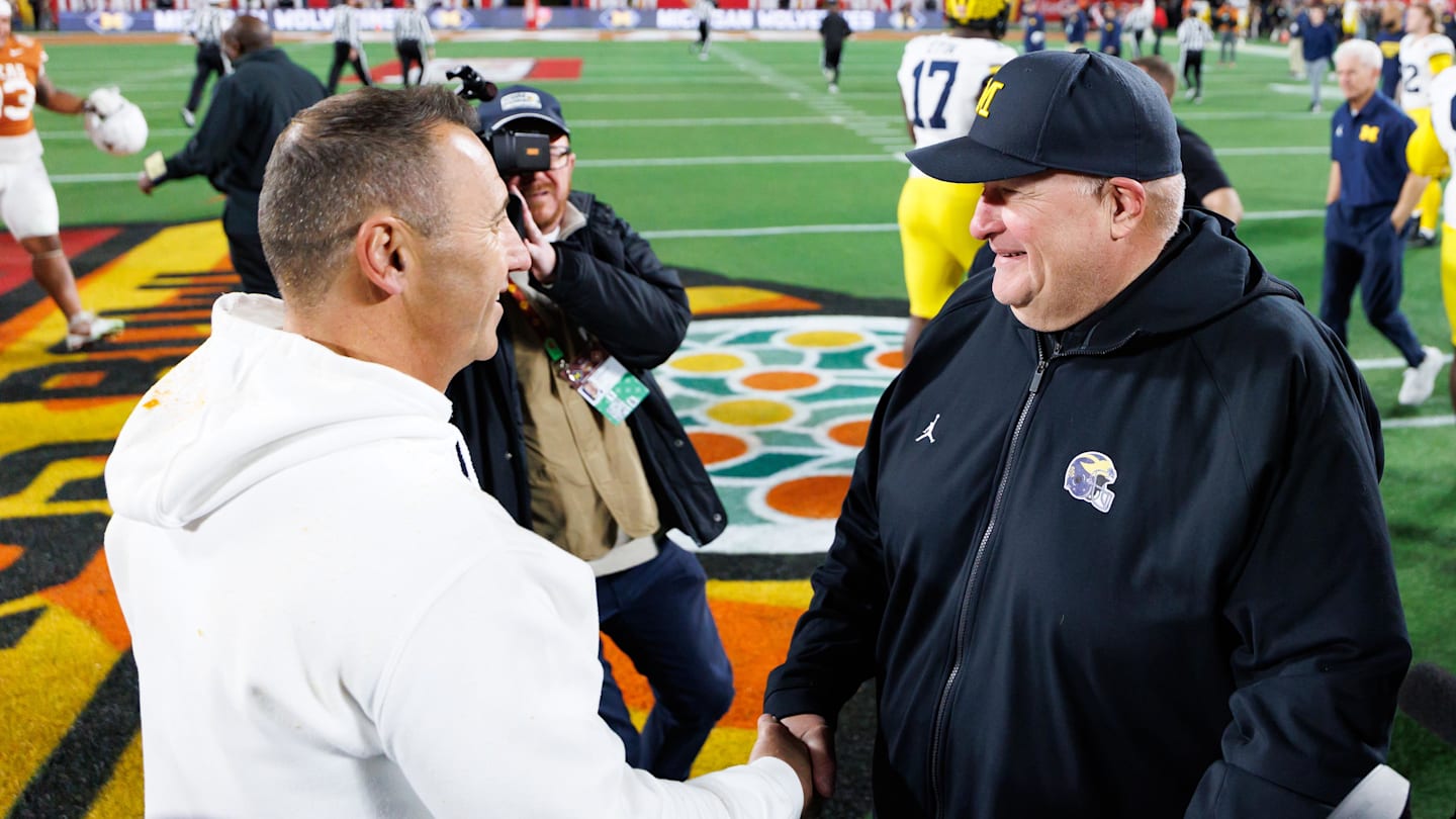 Dec 31, 2025; Orlando, FL, USA; Texas Longhorns head coach Steve Sarkisian and Michigan Wolverines interim head coach Biff Poggi shake hands after a game at Camping World Stadium. Mandatory Credit: Matt Pendleton-Imagn Images