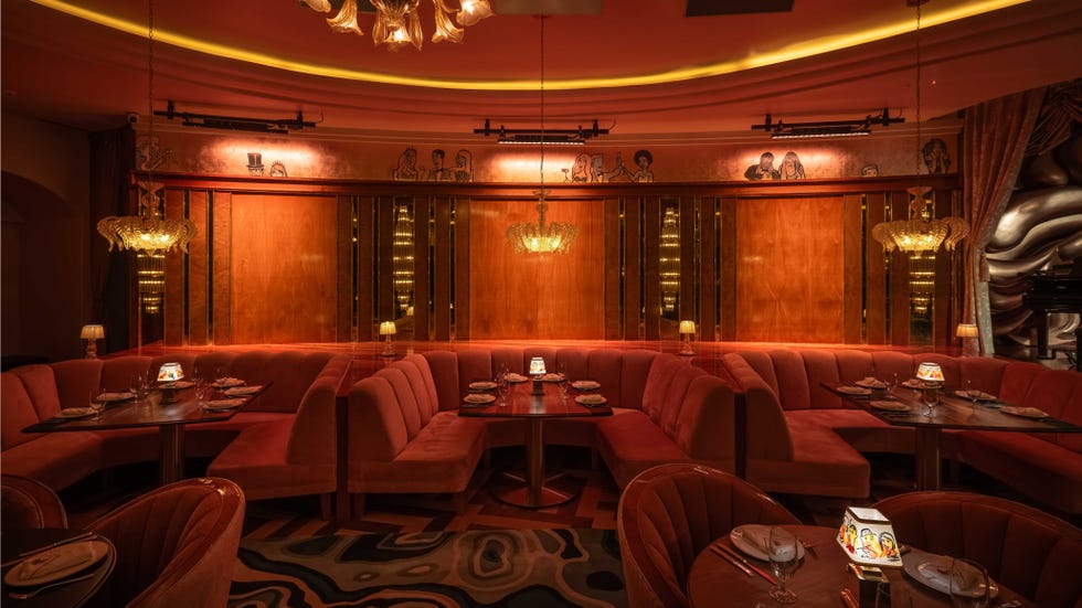 Interior of a stylish dining space with plush seating and ambient lighting.