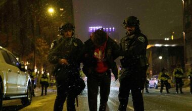 An anti-ICE protester is arrested during a late night protest in Minneapolis