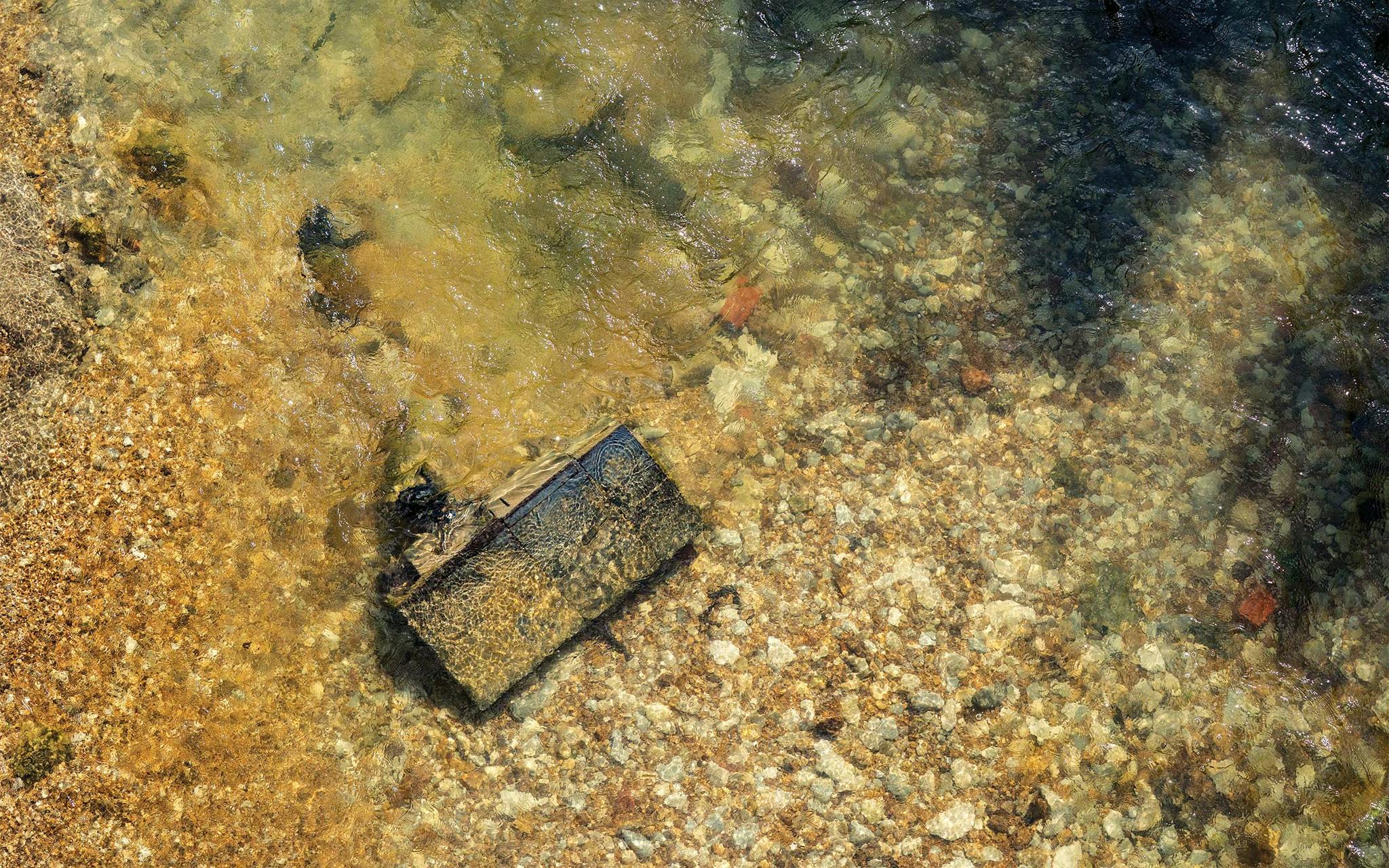 May 10 10:13 A.M. A rusted file cabinet resting on the bottom of Five Mile Creek, in South Dallas.