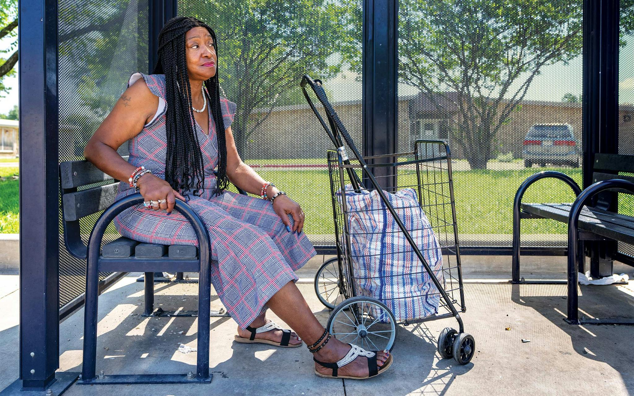 May 10 11:05 A.M.  Sherleene Fields waiting at the bus stop on Bonnie View Road near East Ledbetter Drive. She was on her way to a “Jammin’ and Recovery” event hosted by the Association of Persons Affected by Addiction, an organization she has been involved in, both as a client and as an advocate, for more than a decade.