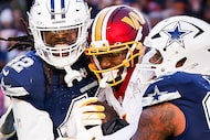Washington Commanders wide receiver Deebo Samuel (1) is wrapped up by Dallas Cowboys...