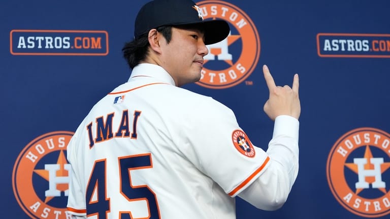 Tatsuya Imai, a right-handed pitcher from Japan, poses for photos...