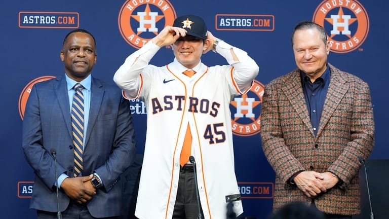 Tatsuya Imai, center, a right-handed pitcher from Japan, is introduced...