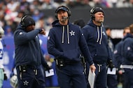 Dallas Cowboys head coach Brian Schottenheimer looks up during the first half of an NFL game...