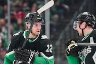 Dallas Stars center Radek Faksa (12)) talks with defenseman Miro Heiskanen (4) before a...