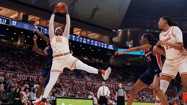 Texas center Kyla Oldacre (00) grabs a rebound over Auburn...